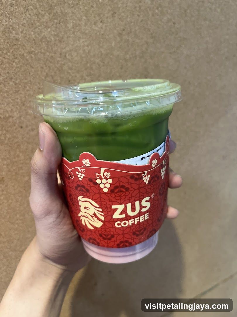 Hand holding a beverage cup