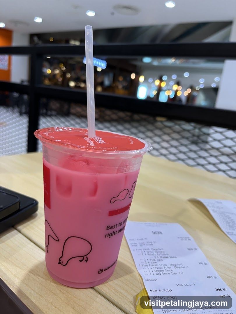 Pink beverage with receipt on table