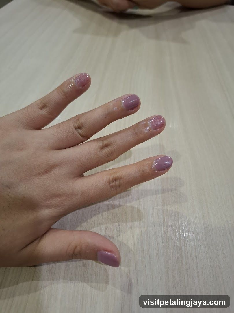 Hand with freshly painted nails