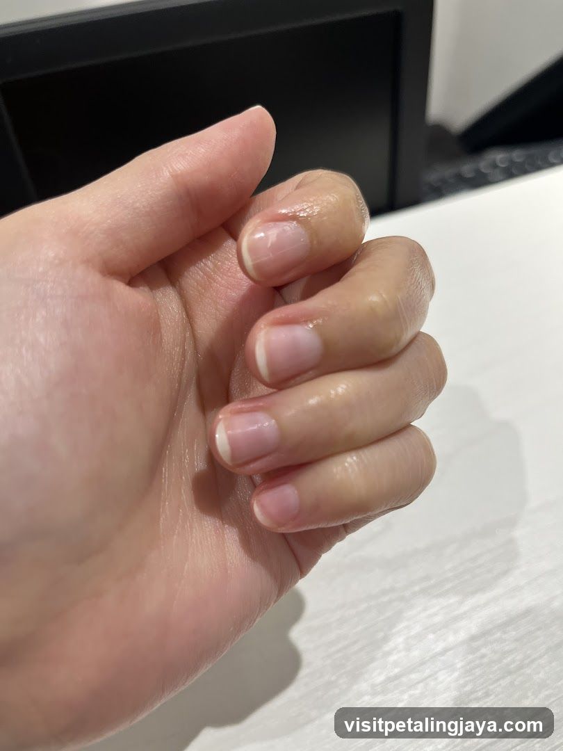 Close-up of a hand with French manicure