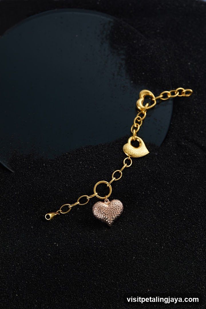 Gold bracelet with heart charms