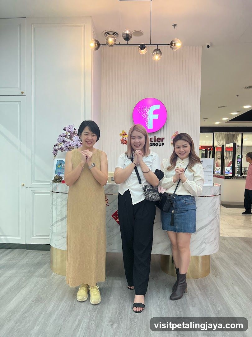 Three women posing at a reception desk