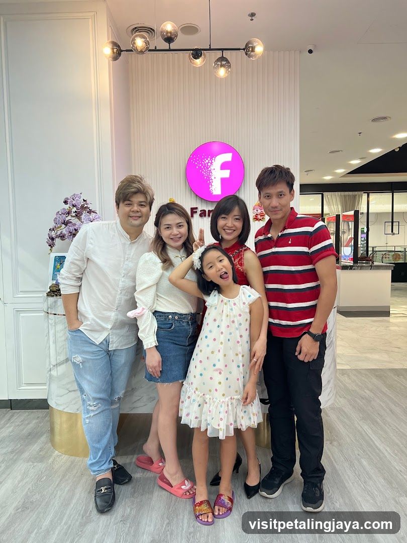 Group Posing in Front of a Business Logo