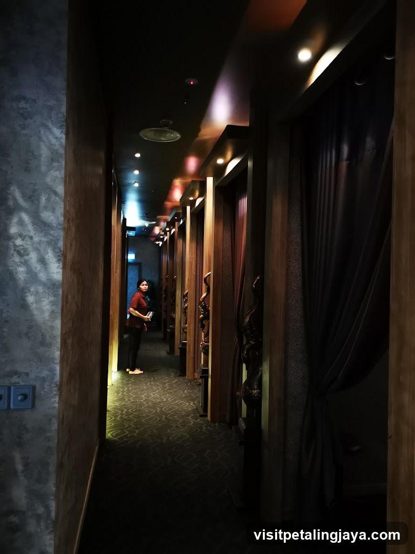 Dimly lit corridor with person standing near entrance