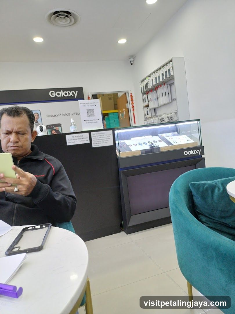 Man looking at phone in a Galaxy store