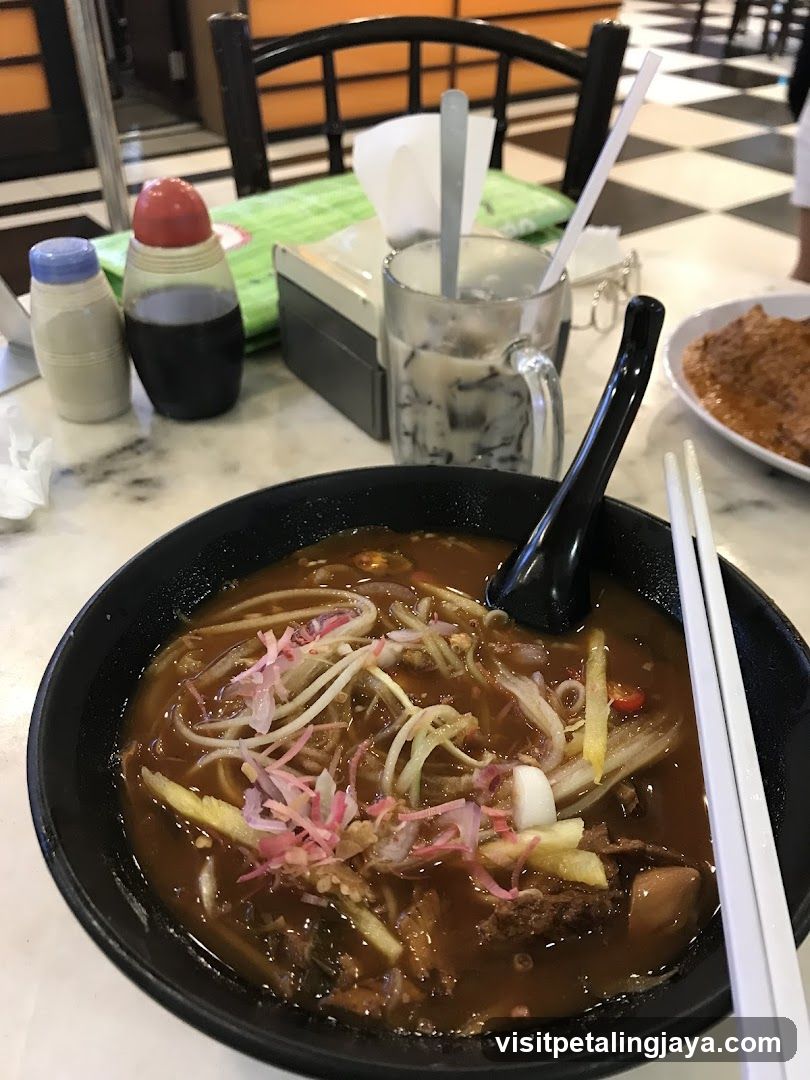 Bowl of noodles with condiments and drink