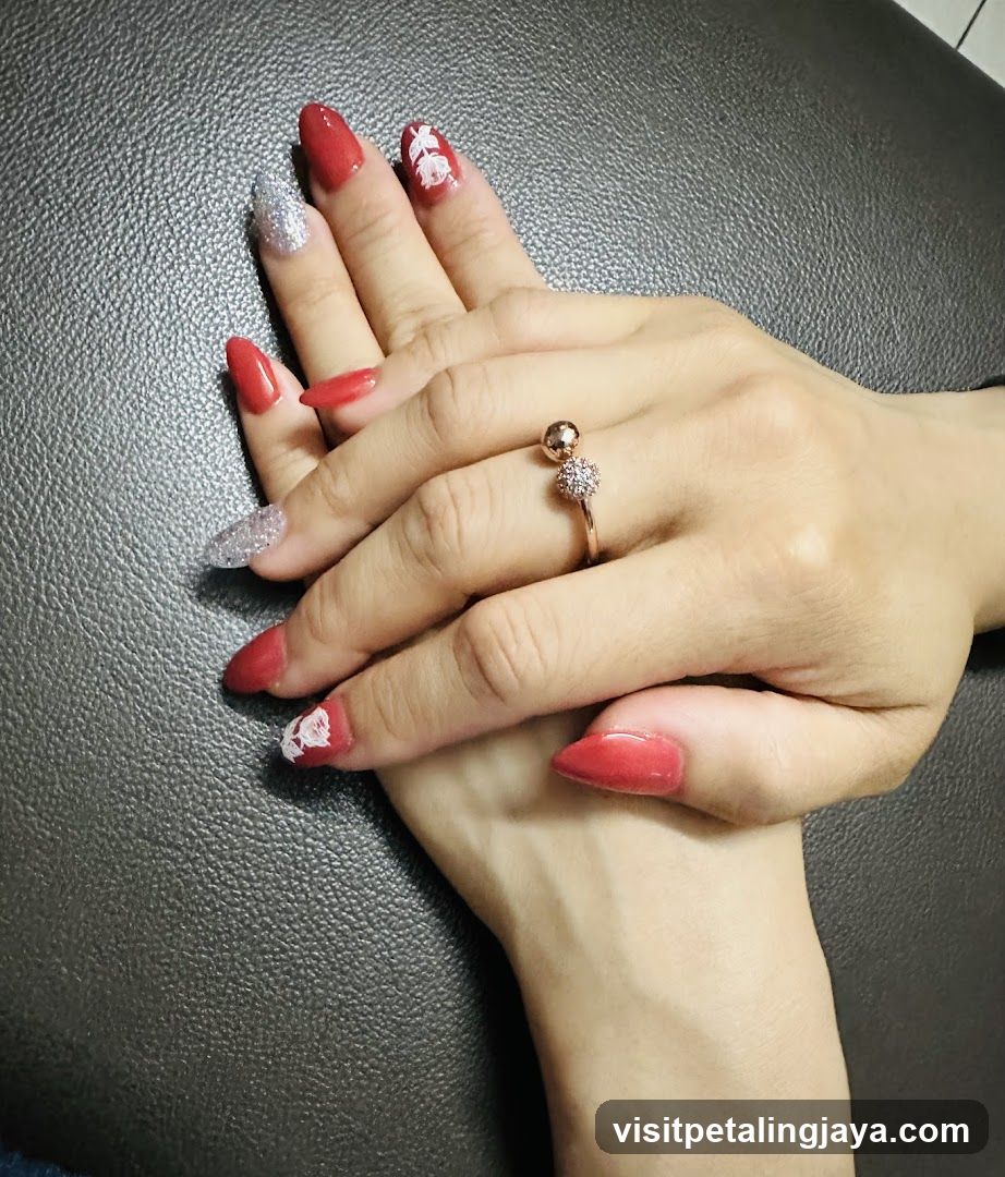 Woman's hands with red and silver nail polish