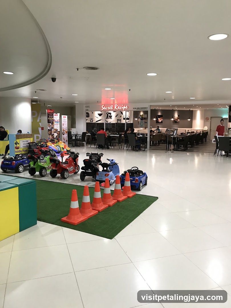 Indoor play area with toy cars and a cafe