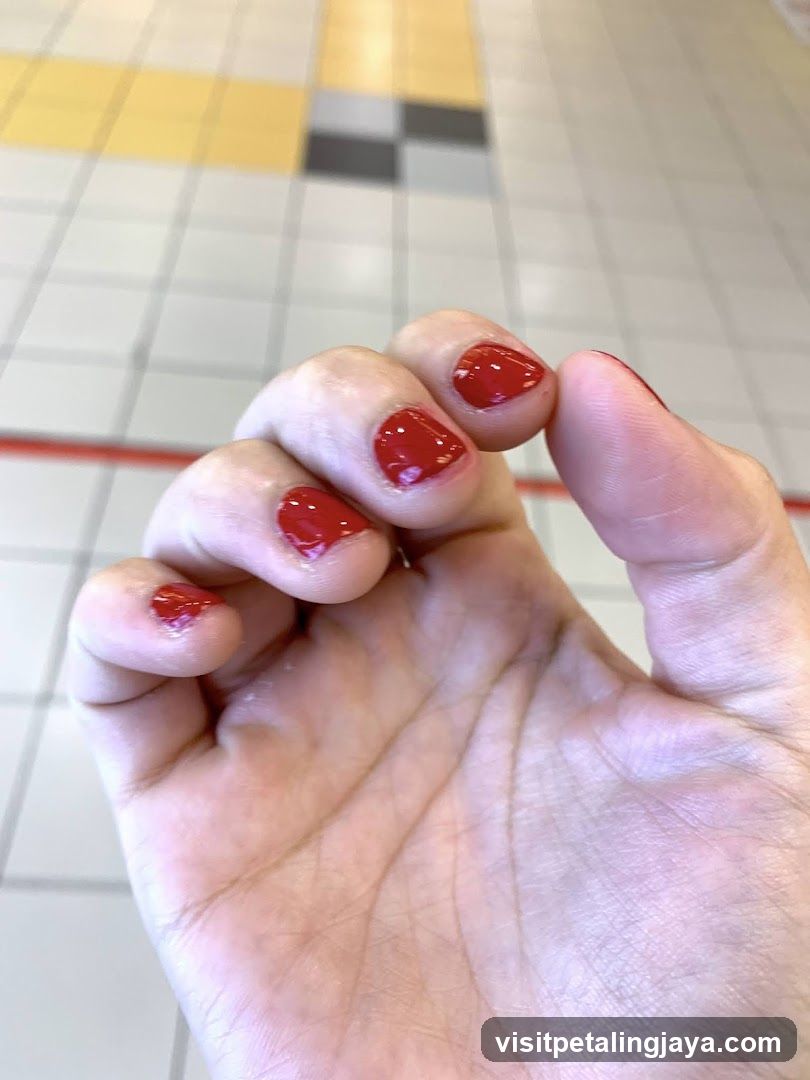 Red Nail Polish on Hand