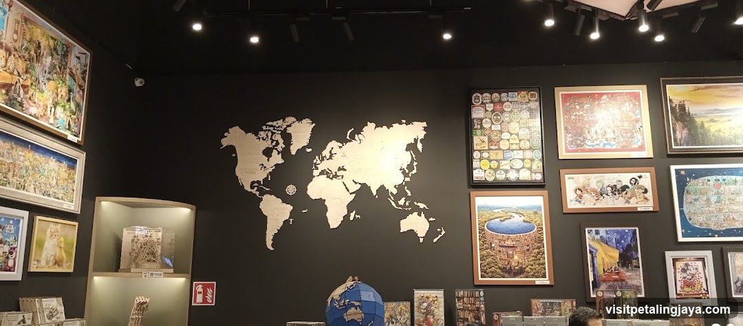 Puzzles and artwork displayed on a dark wall