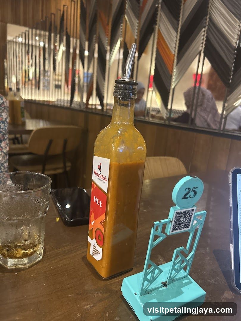 Nando's Hot Sauce Bottle on Table