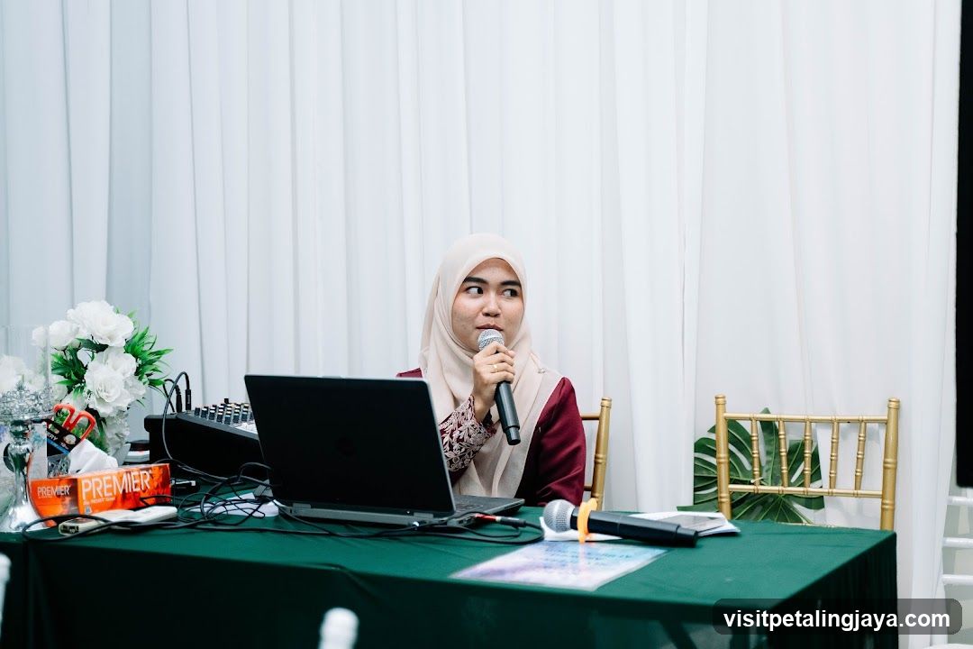 Woman Speaking into Microphone at a Table