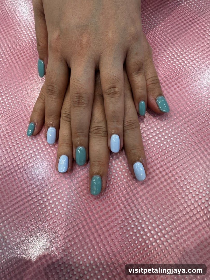 Manicured Hands with Blue and Teal Polish