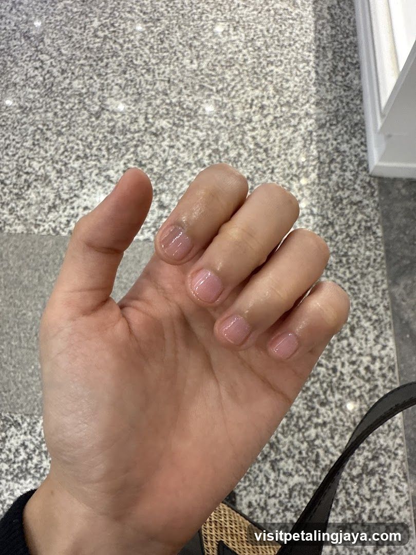 Hand with light pink nails