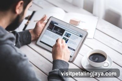 Person Using Tablet at Table with Coffee