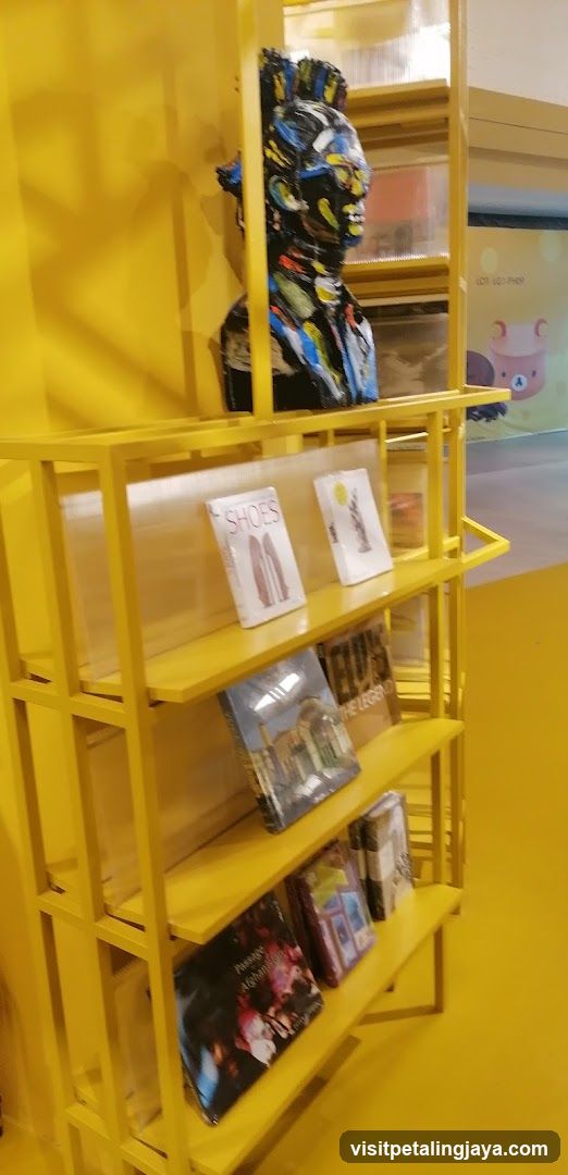 Yellow Display Shelf with Artifacts and Books