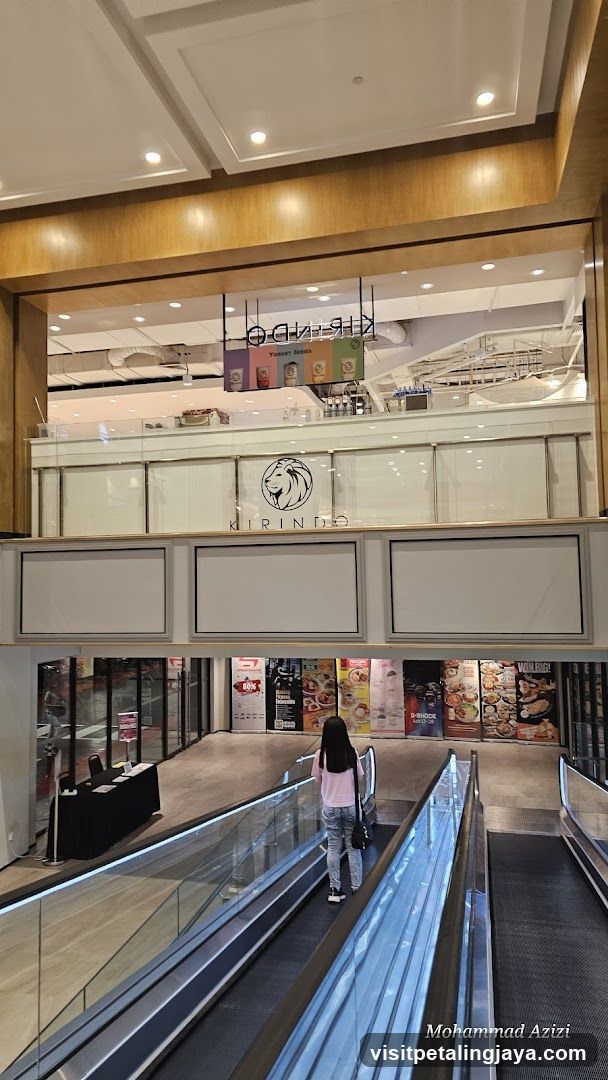Shopping Mall Interior with Escalator and Storefronts