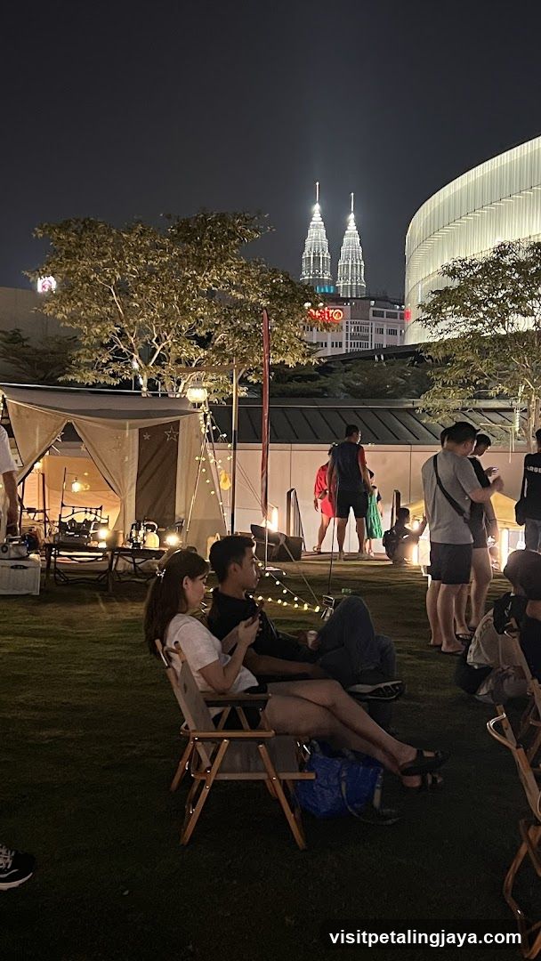 Night Outdoor Gathering with Petronas Twin Towers in Background