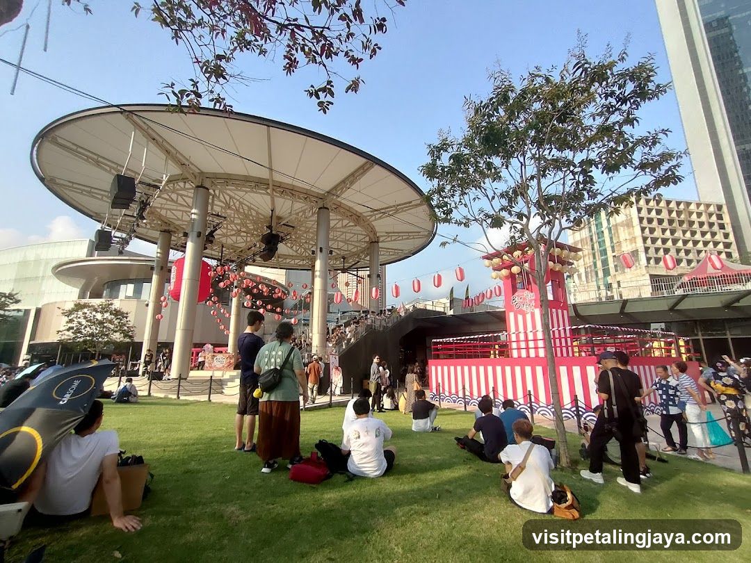 Outdoor Event with Stage and Crowd