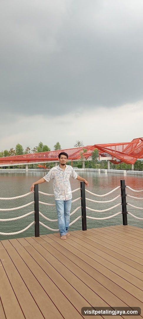 Man on a wooden deck by a lake