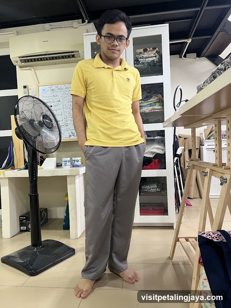 Man in yellow polo shirt and grey pants