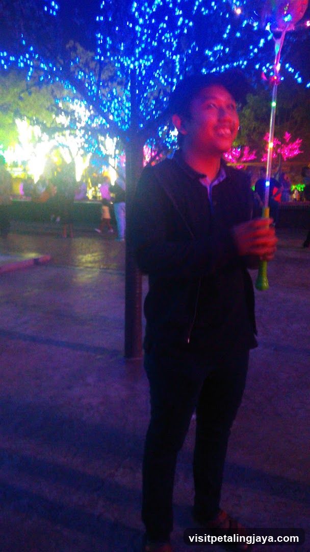 Person holding a light-up toy at night
