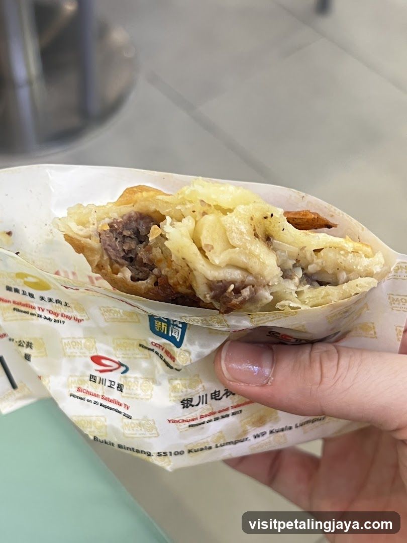 Hand holding a wrapped food item
