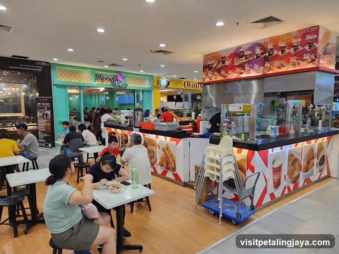 Food court with various stalls and diners