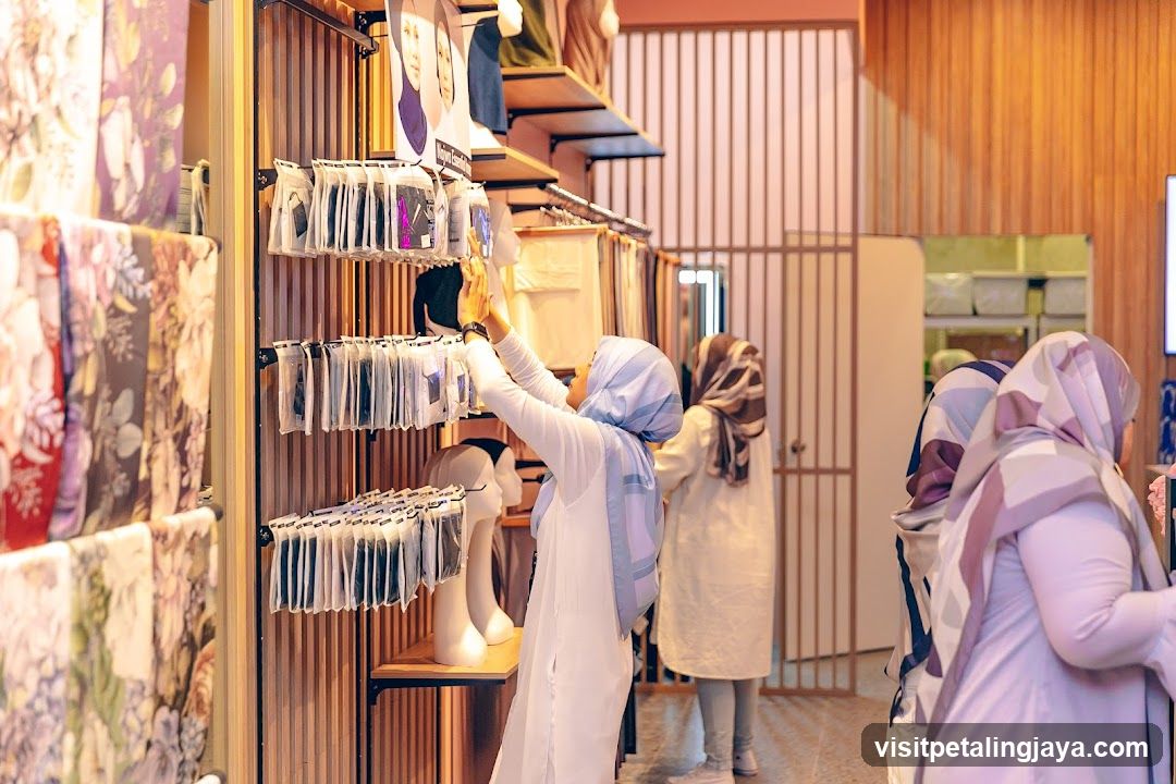 Customers browsing scarves in a store