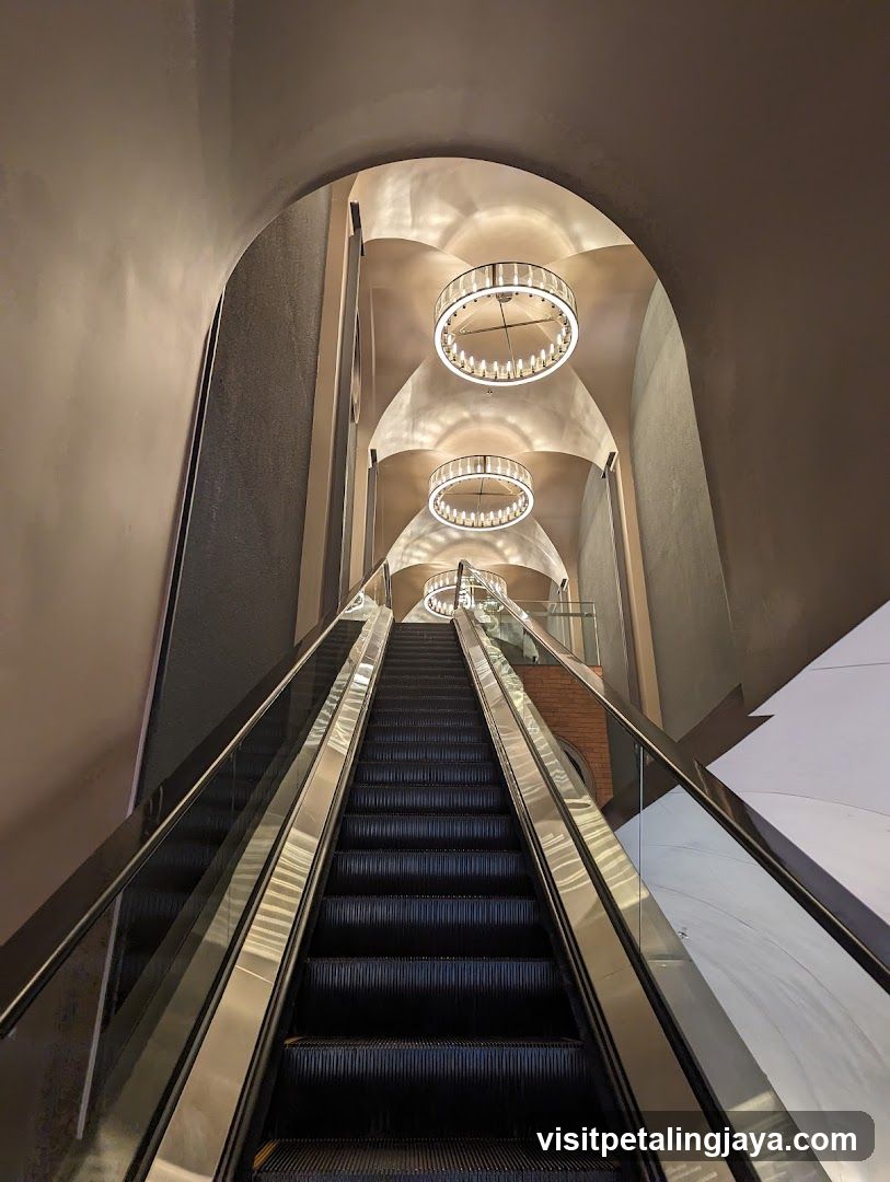 Elevated Interior Staircase with Chandeliers
