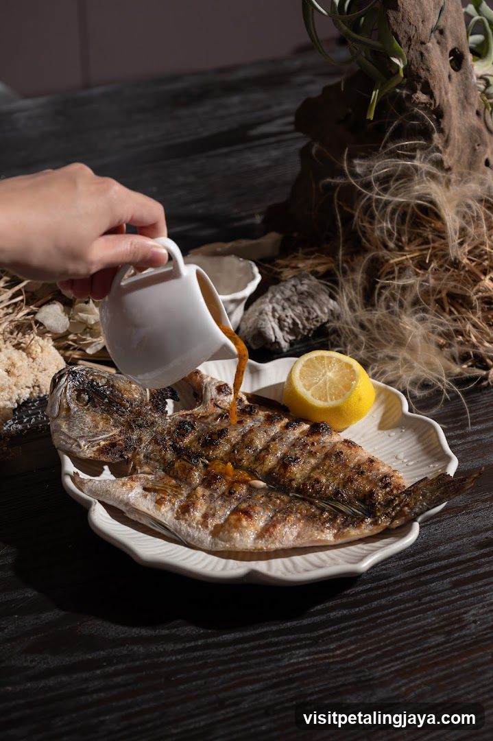 Grilled Fish with Sauce Pouring