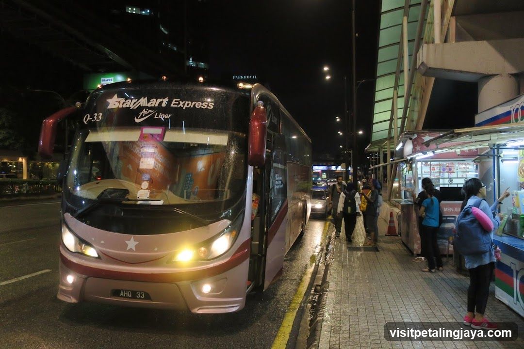 Night street scene with bus and food stall