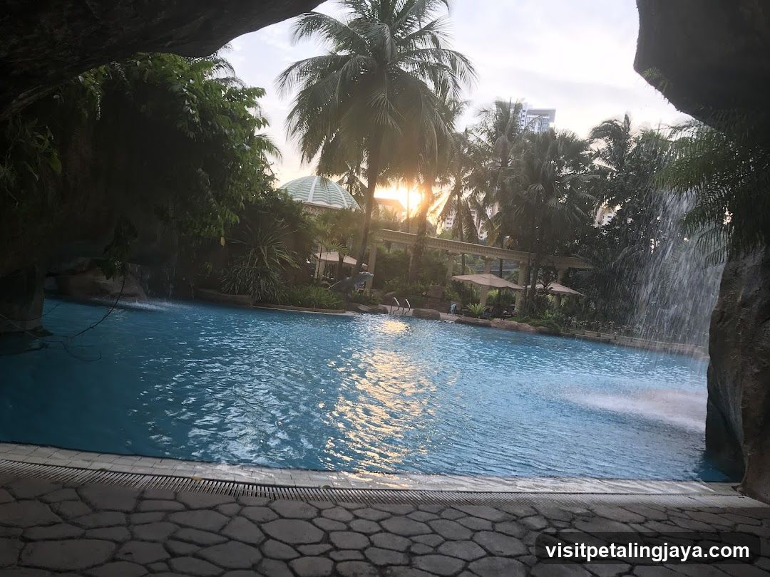 Resort Pool with Waterfall and Palm Trees