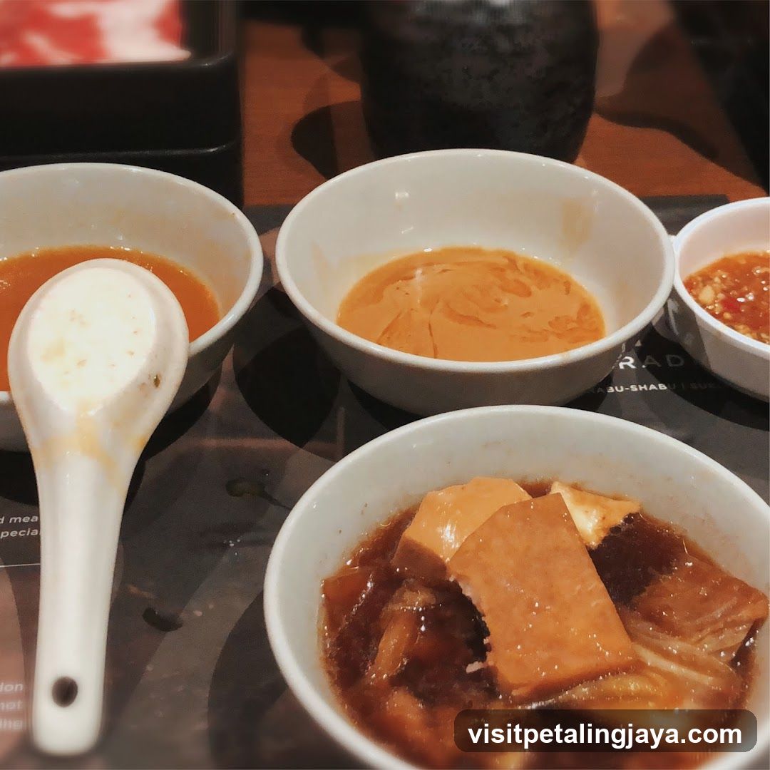 Dining Table with Bowls of Soup and Sauce