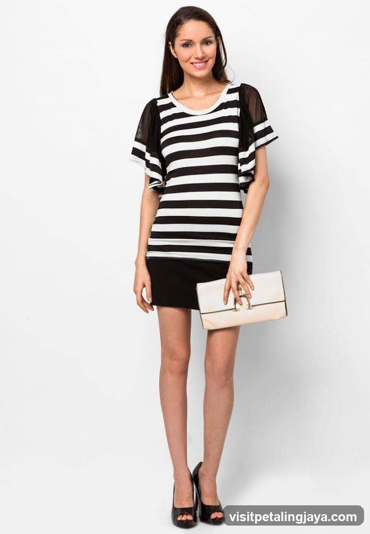 Woman in striped dress and black skirt