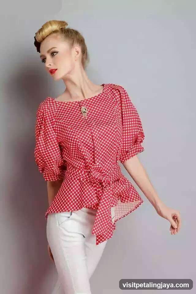 Woman in polka dot blouse and white pants