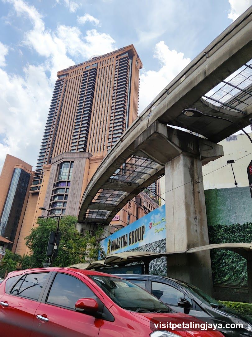 Urban street scene with elevated train track and high-rise building
