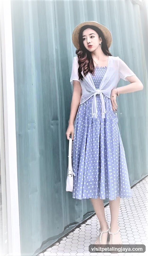 Woman in polka dot dress and straw hat