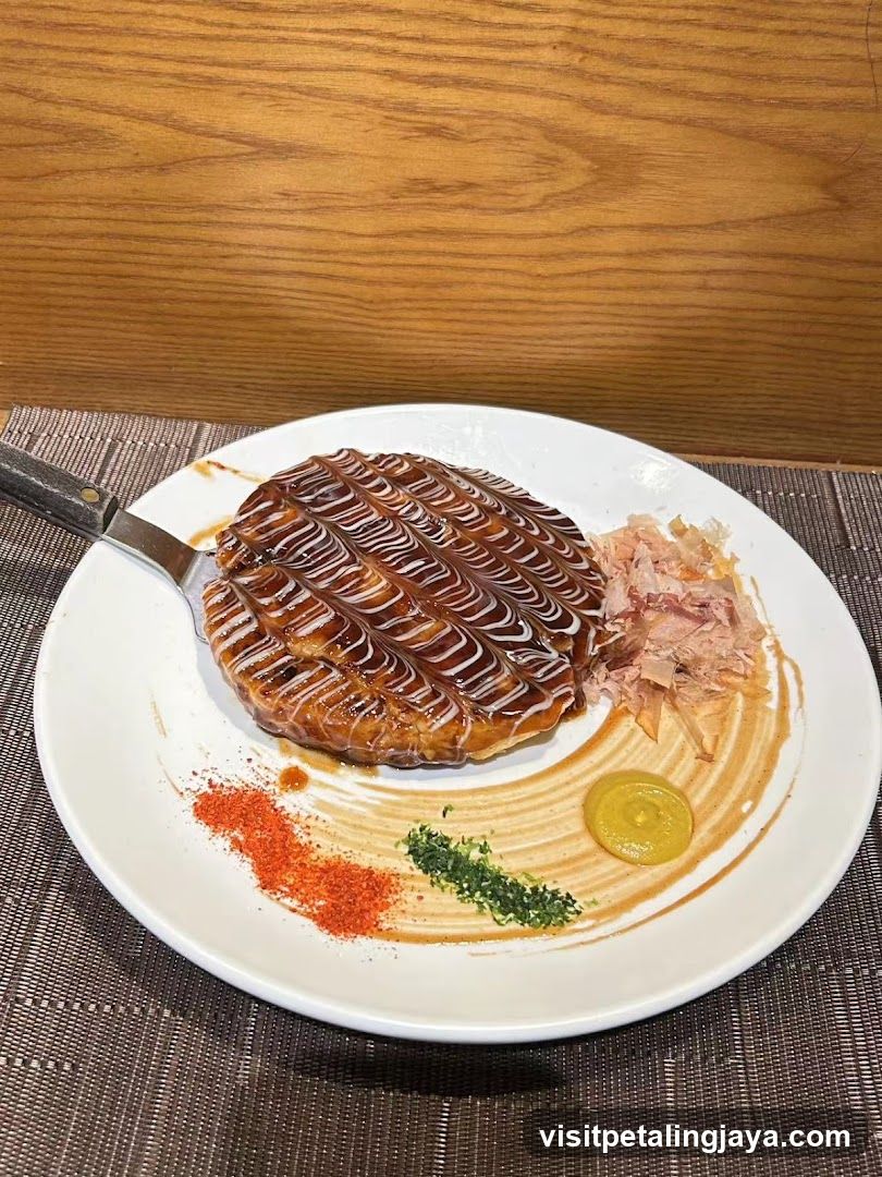 Okonomiyaki with toppings and sauces