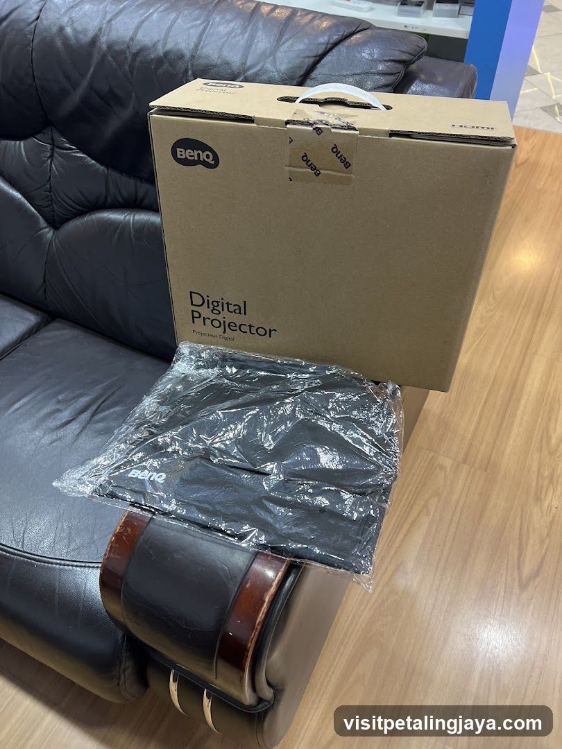 BenQ Digital Projector Box on Leather Sofa