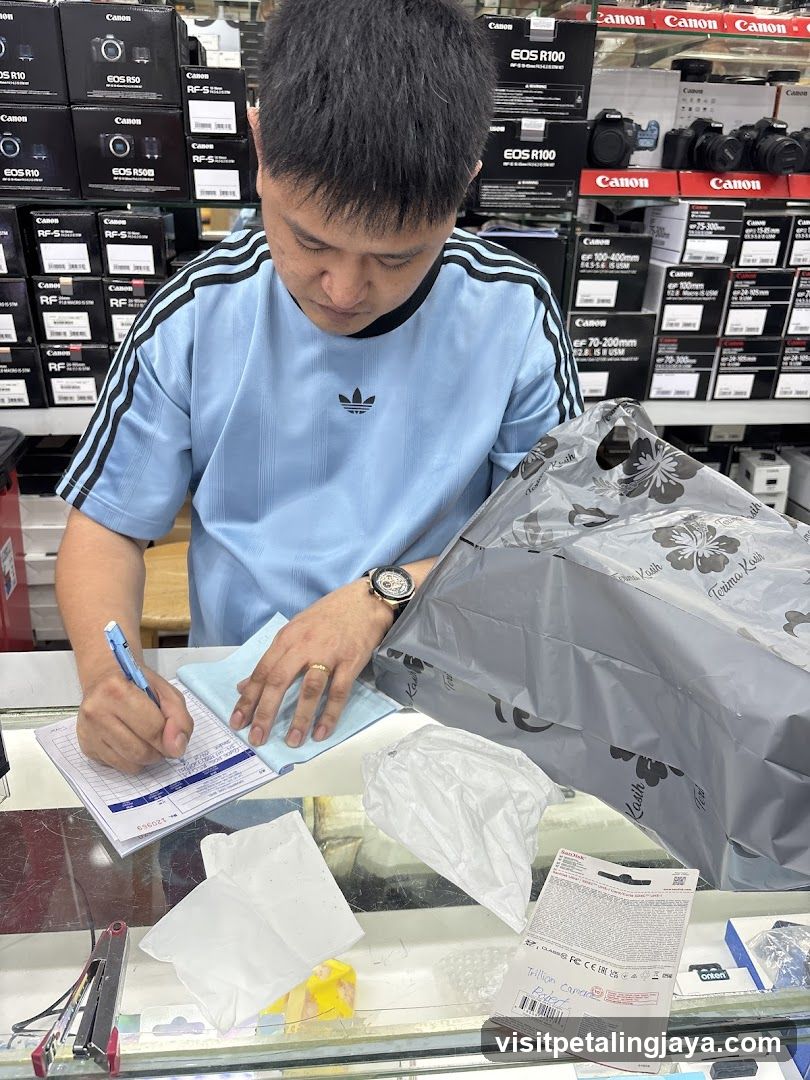 Customer Signing Documents at Electronics Store