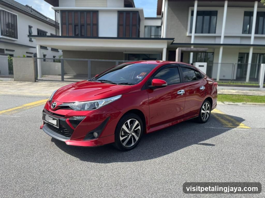 Red Toyota Yaris parked in residential area