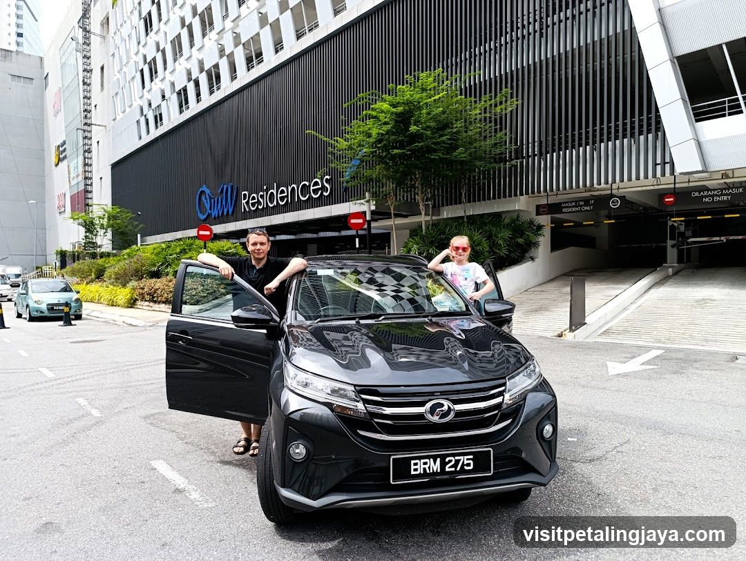 Car in front of building with signage