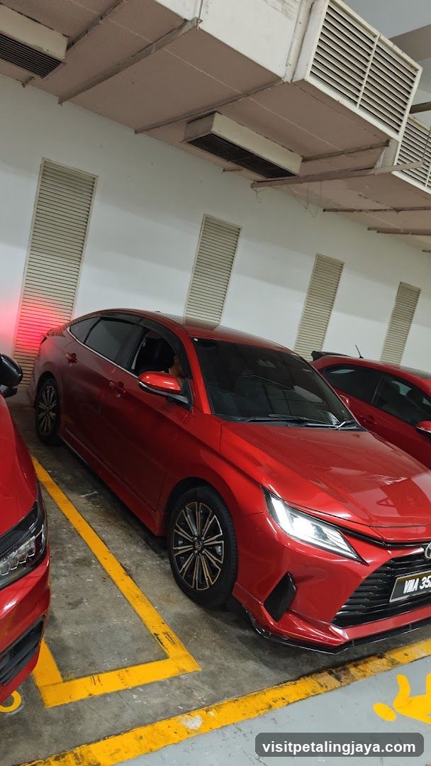 Red Sedan in Parking Garage
