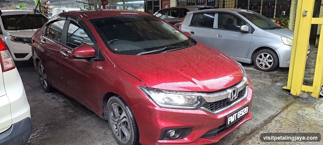 Red Honda City parked in lot