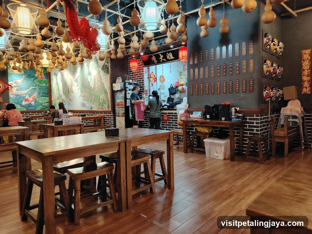 Interior of a Chinese-style restaurant with hanging gourd decorations and wooden furniture.