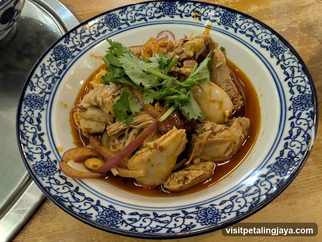 Bowl of Spicy Chicken with Cilantro and Onions