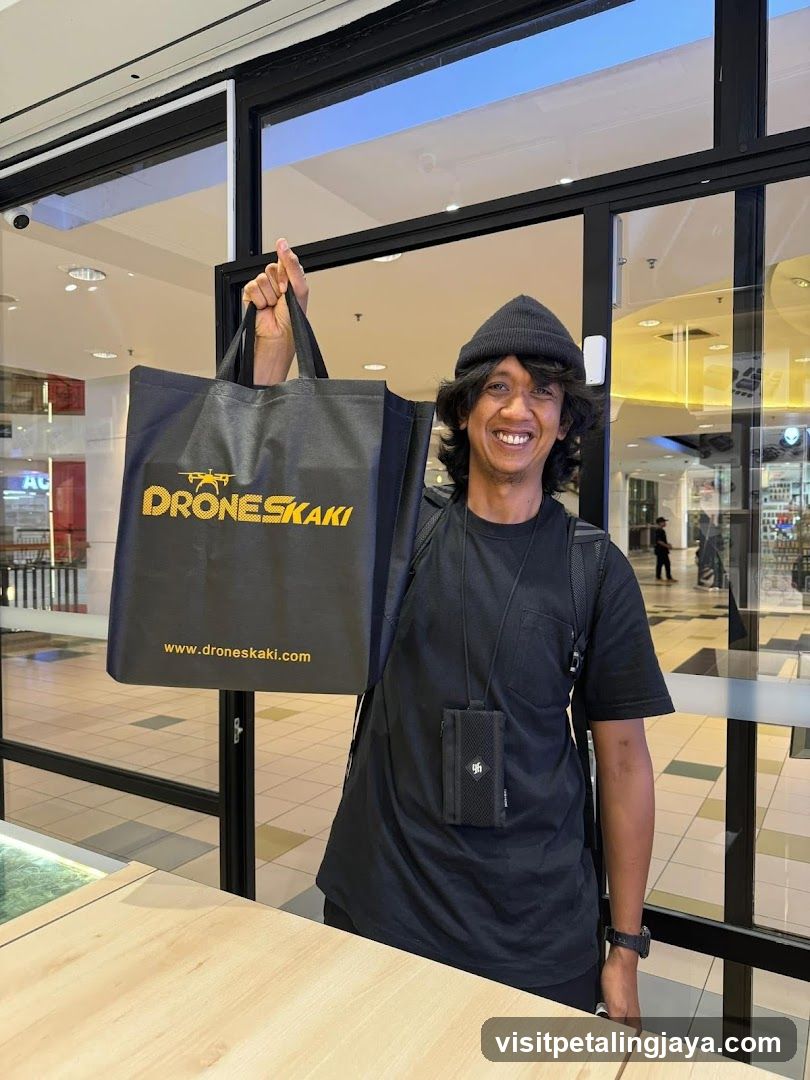 Person holding branded tote bag