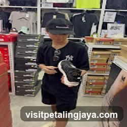 Person holding shoes in store