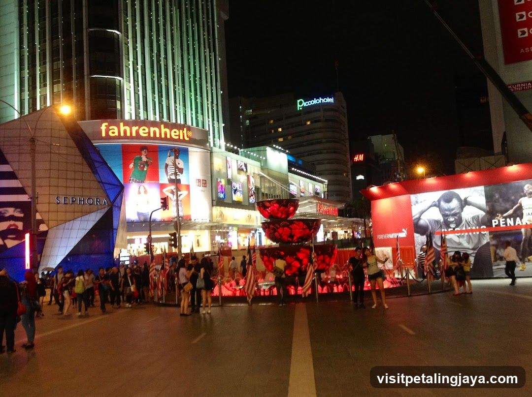 Night City Street Scene with Storefronts and Crowds
